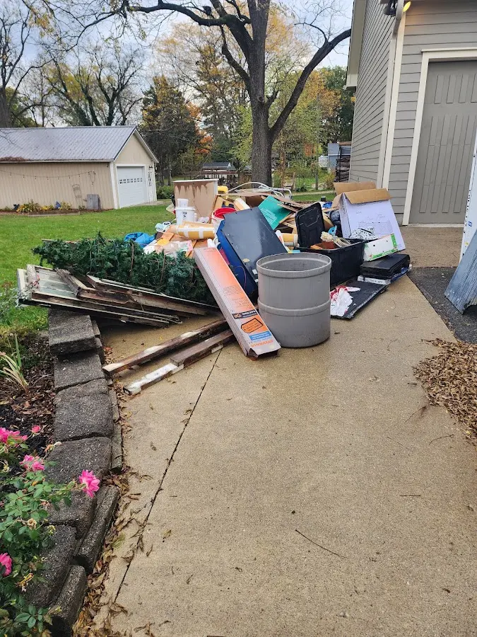 Dumpster being loaded with debris for Estate Cleanout Dumpster Rental in Interlaken